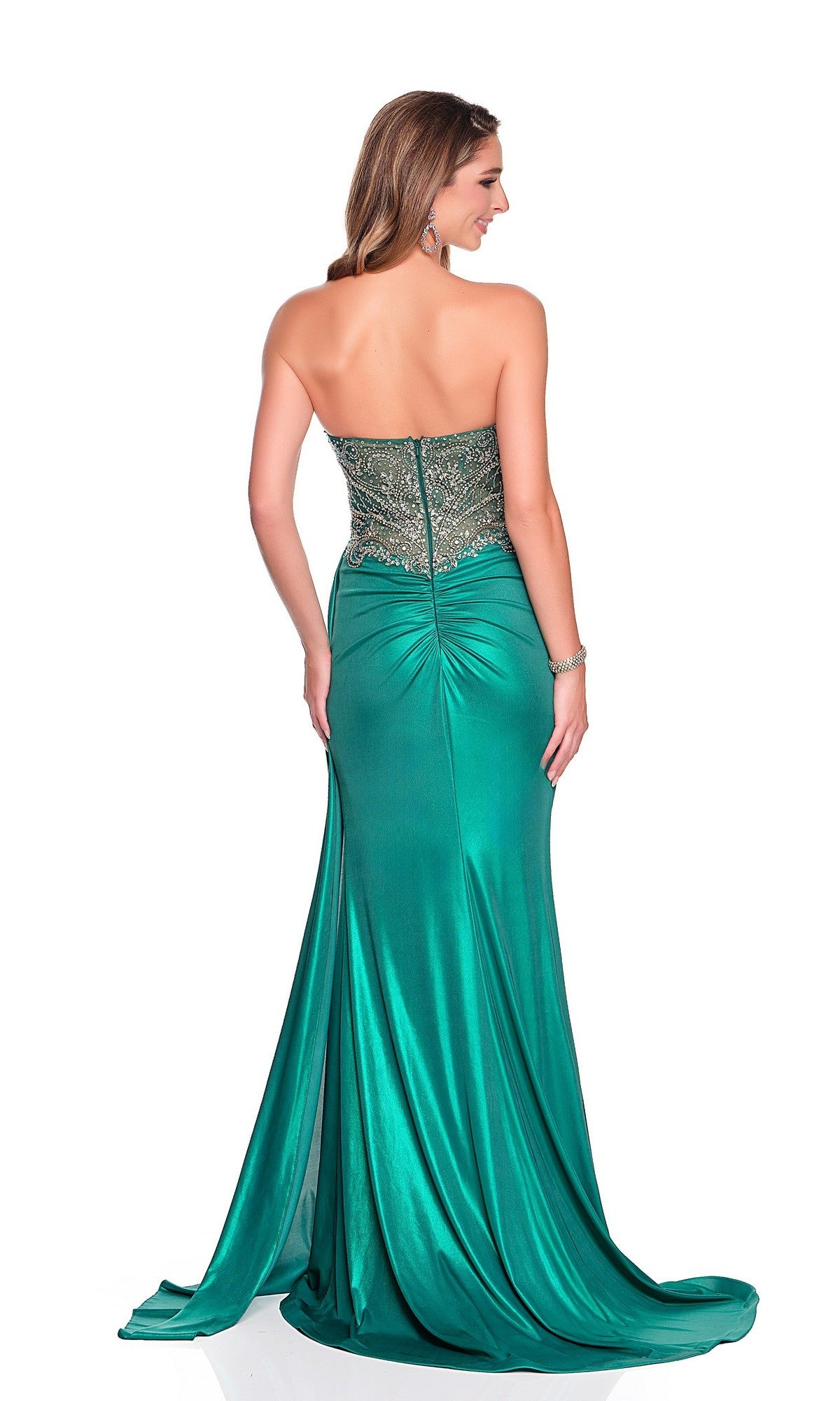 A woman stands with her back to the camera in a Dave and Johnny 12396 long prom dress featuring a strapless green design, embellished bodice, and satin sheath skirt against a white background.